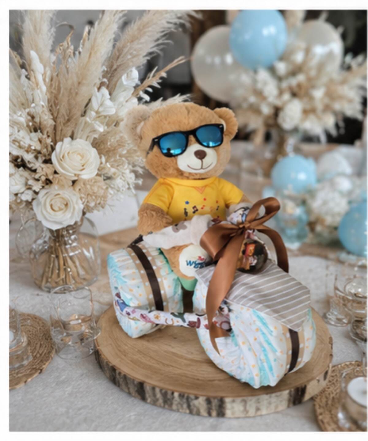 Nappy trike in warm neutrals with a yellow-shirted teddy in the saddle
